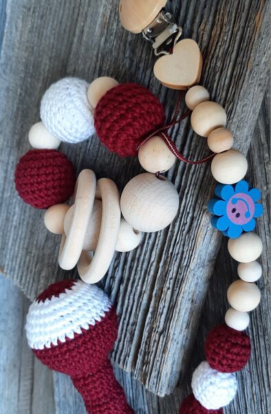 Lalu grabuļu komplekts mazuļiem ''Sarkanbalti sarkanais".  Graužamriņķis, knupīšu turētājs un grabulis kātiņā ar maigas skaņas zvārgulīti. 