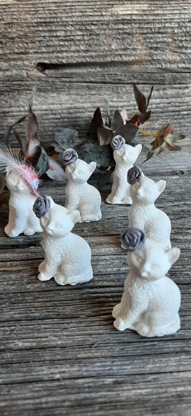 Kaķa figūriņas ar rozītēm un cepurītēm.